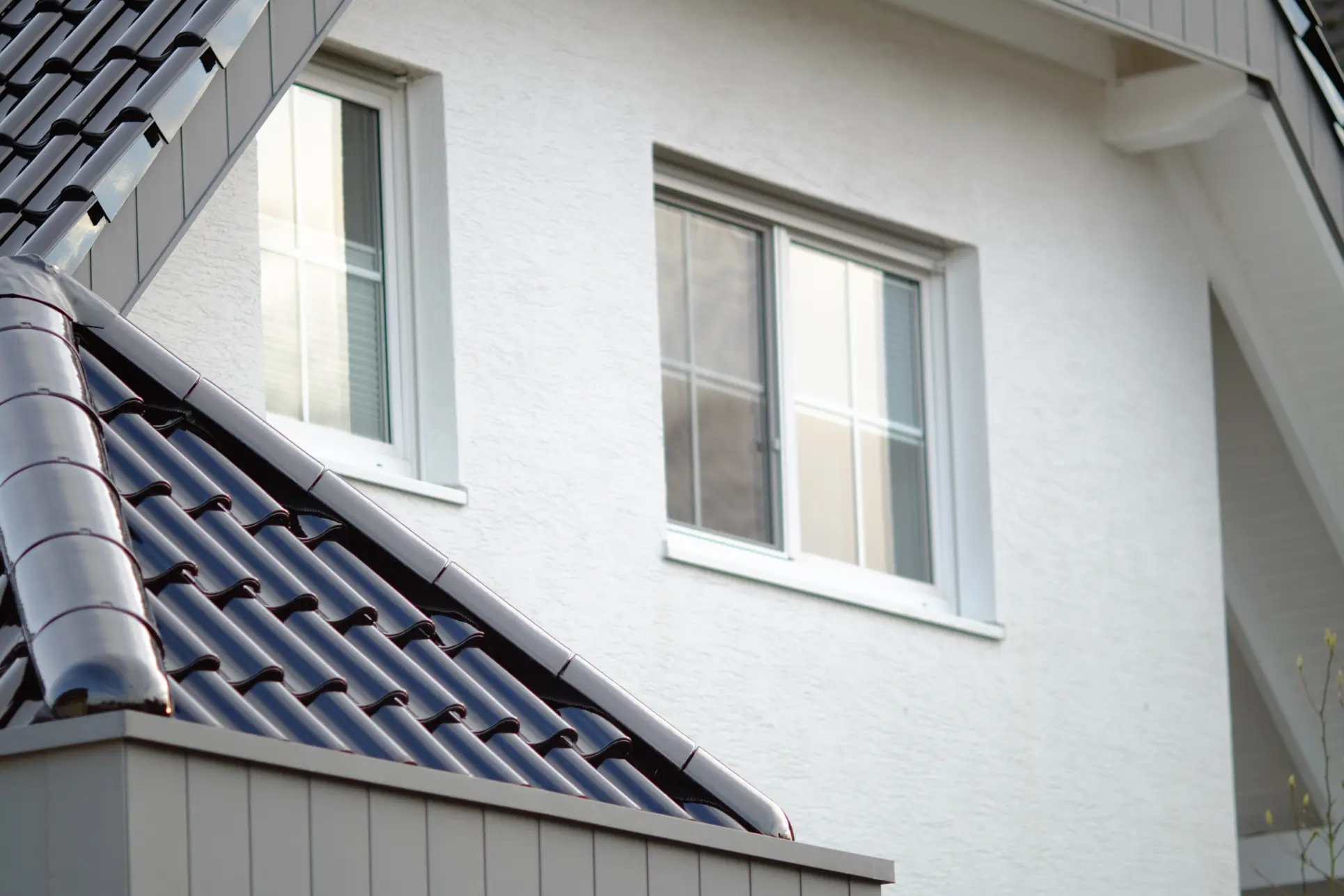 New modern window installation on white house exterior